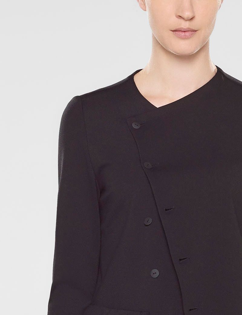 Black long fitted assymetrical style jacket by Sarah Pacini