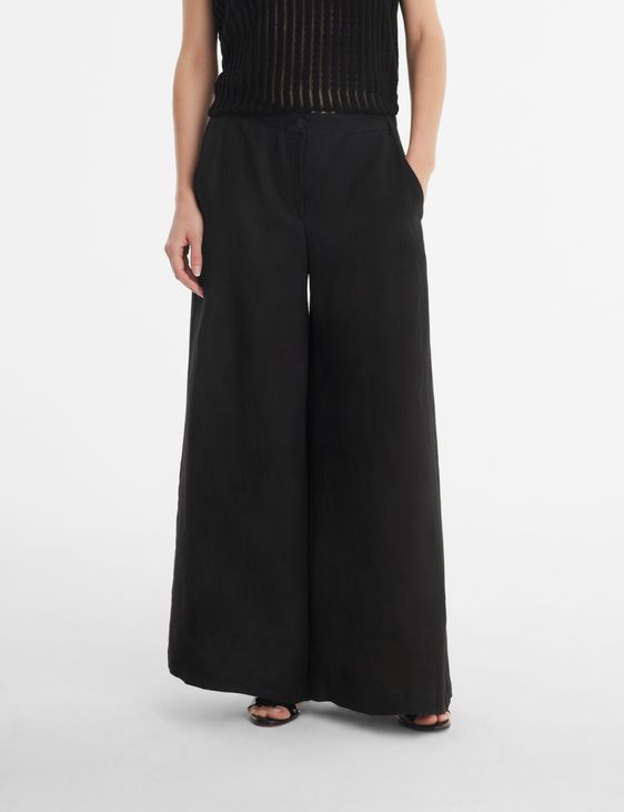 Black linen linen palazzo pants by Sarah Pacini